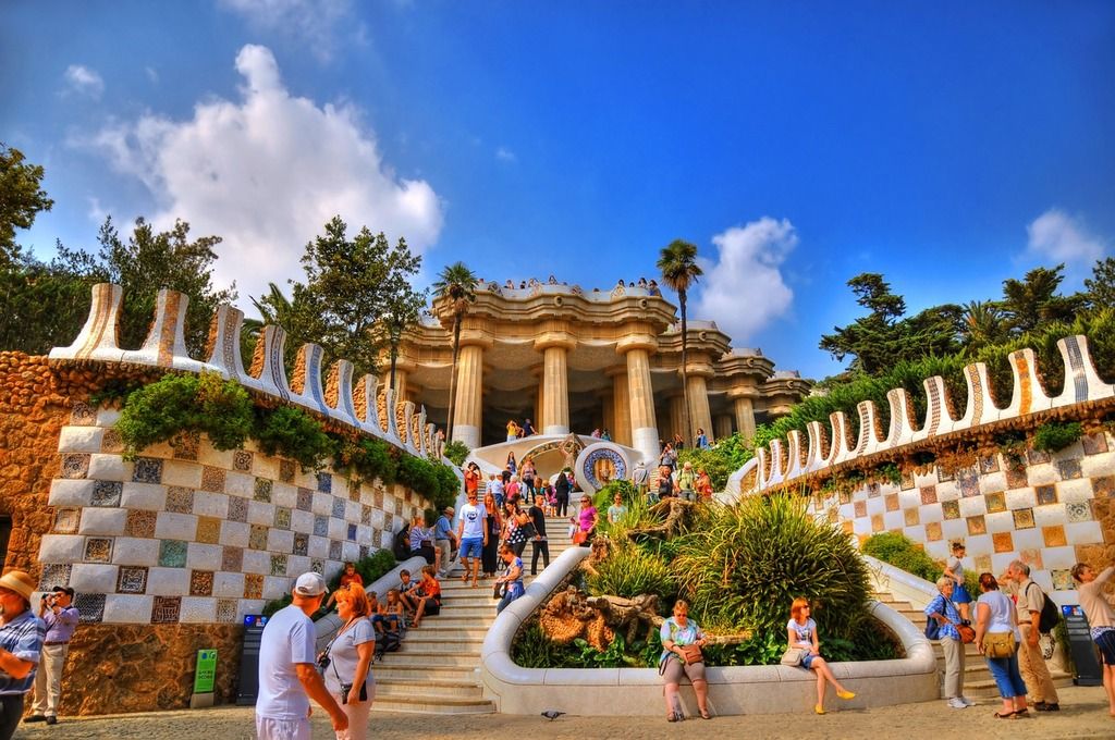 Die farbenfrohen Mosaikdesigns und die kunstvolle Architektur des Park Güell in Barcelona.