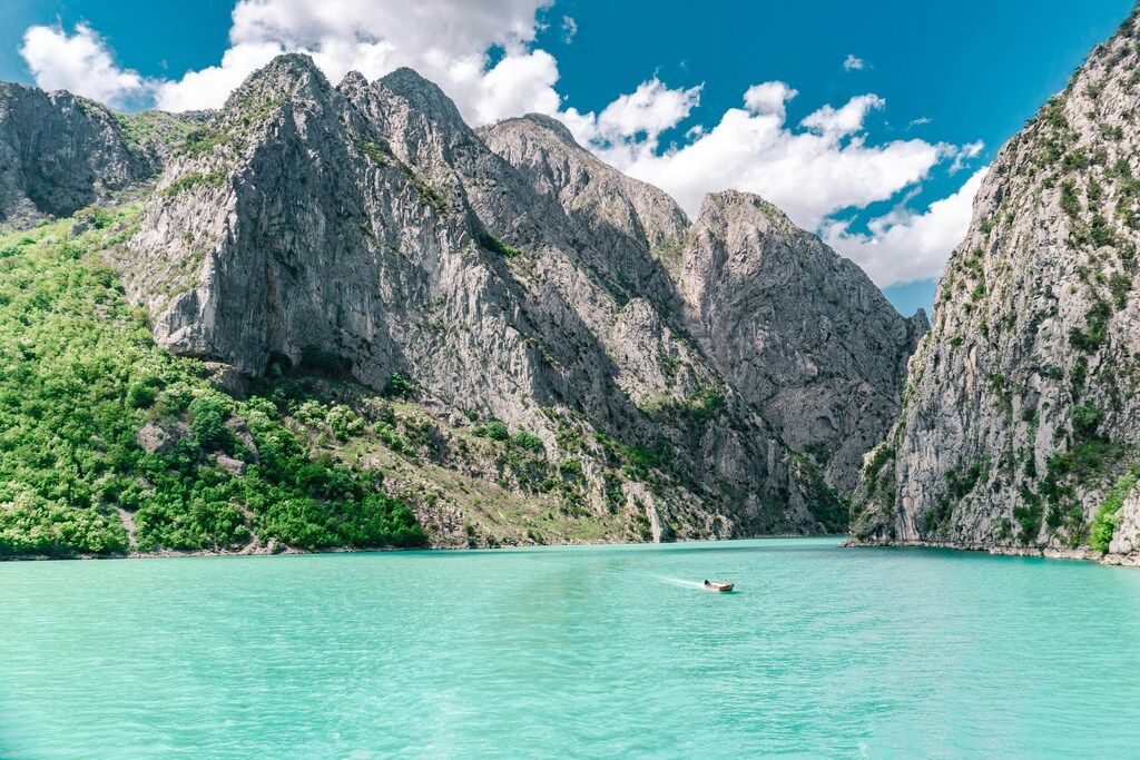 Türkisblaues Wasser und beeindruckende Felswände im Koman-Stausee