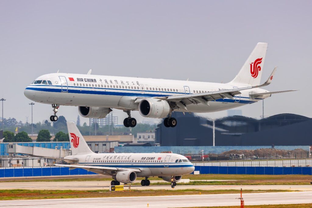 Two Air China aircraft landing and taking off on an airport runway.