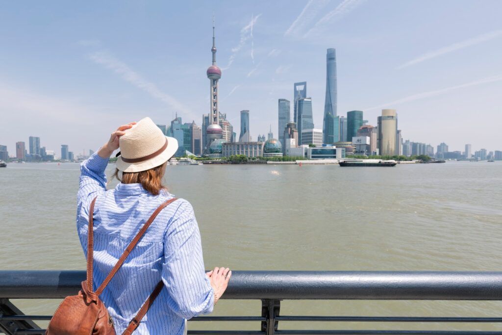 Tourist admires the Shanghai skyline with the Oriental Pearl Tower.